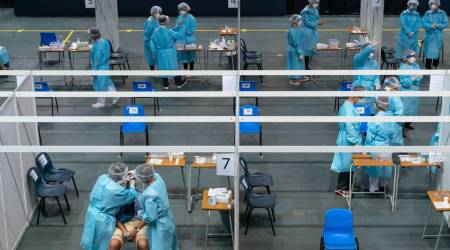 Healthcare workers collect a swab sample at a testing center for the government's Universal Community Testing Programme in Hong Kong on Sept. 1.