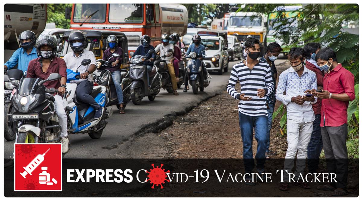 Commuters wearing masks wait at a traffic intersection in Kochi, Kerala (AP)