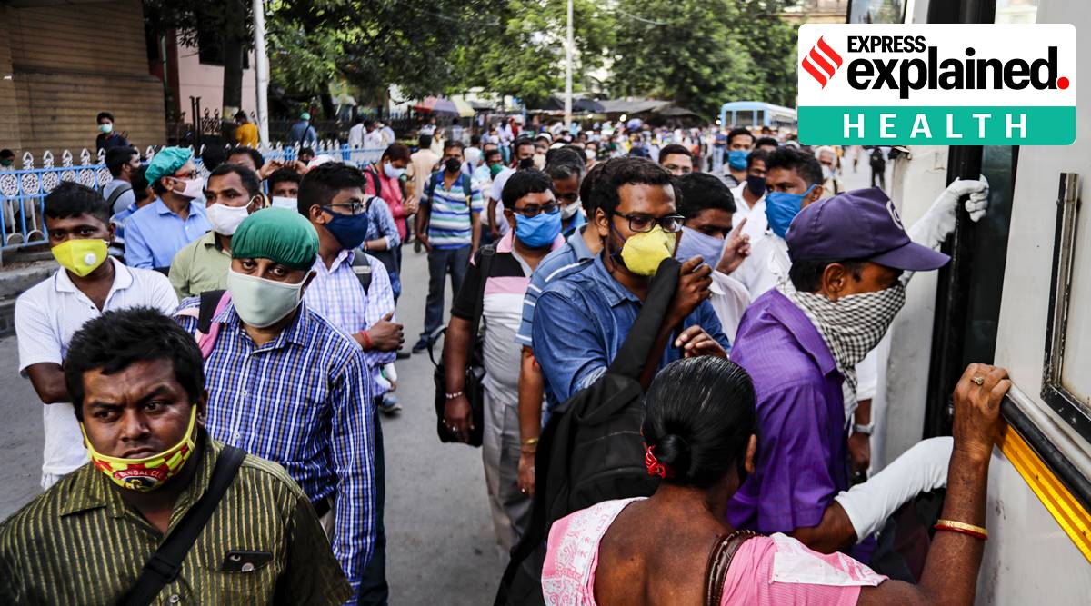 Commuters board a bus in Kolkata. An observational study across the country found nearly half of 4,500 people were either not wearing masks or were not wearing them properly. (AP Photo)