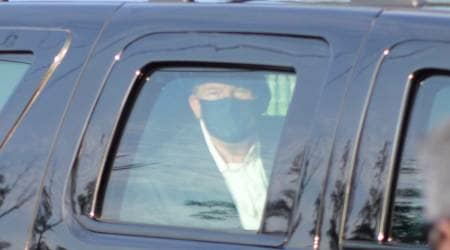 President Donald Trump drives past supporters gathered outside Walter Reed National Military Medical Center in Bethesda, Md., Sunday, Oct. 4, 2020. Trump was admitted to the hospital after contracting COVID-19. (AP Photo/Anthony Peltier)