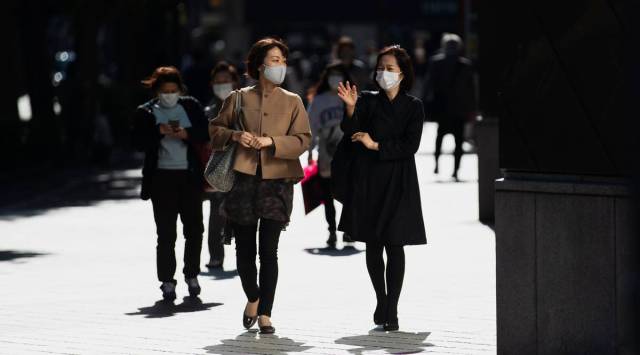 Women with face masks walk on a street in Tokyo (AP Photo/Hiro Komae)