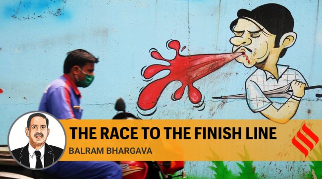 A man drives past a wall painting spreading the message of not spitting in public places. As part of efforts to slow the spread of coronavirus, Maharashtra government has decided to enforce action against all those found spitting in public. (Express Photo by Amit Chakravarty)