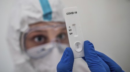 A member of the medical staff performs a rapid IgG/IgM test for COVID-19 antibody detection at a corona test center (AP)
