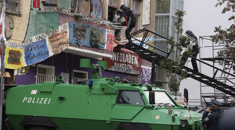 During the eviction, police officers use a turntable ladder to go through a window of the squatted house "Liebig 34" in Berlin, Germany, Friday, Oct. 9, 2020. (AP)