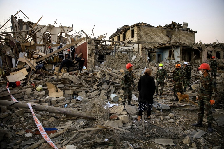 Search and rescue teams work on a blast site hit by a rocket during the fighting over the breakaway region of Nagorno-Karabakh, in the city of Ganja, Azerbaijan October 17, 2020. REUTERS/Umit Bektas