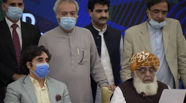 Pakistani opposition parties leaders Maulana Fazal-ur-Rehman, front right, reads out a statement while Bilawal Bhutto Zardari, front left, looks on at a press briefing following their All Parties Conference, in Islamabad, Pakistan. (AP)