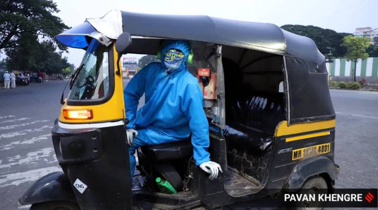 Prabhu Shisharnappa Banshette, 37, offers rides to citizens, including Covid-19 patients, wearing a PPE kit in Pune. (Express Photo: Pavan Khengre)