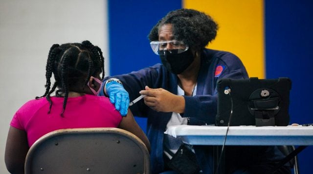 A flu shot is administered in Chicago, Oct. 24, 2020. The president has continued to downplay the severity of the coronavirus and declare before largely maskless crowds that it is vanishing. The surge in new cases across the country suggests otherwise. (Taylor Glascock/The New York Times)