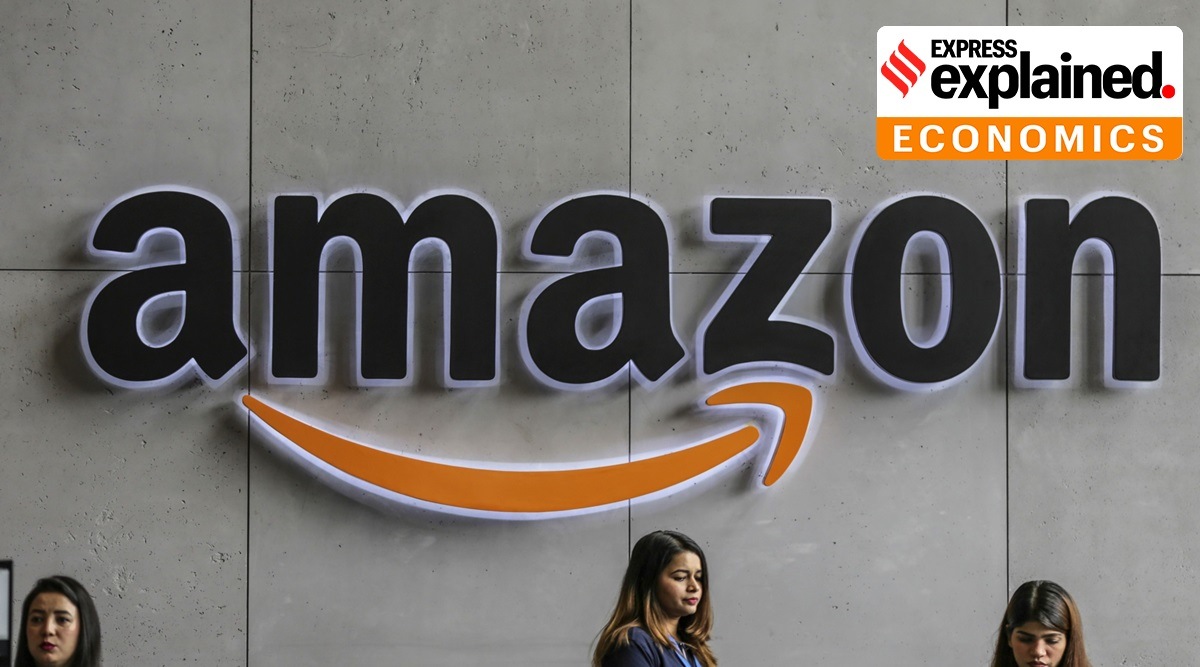 Employees stand near an The Amazon Inc. logo is displayed above the reception counter at the company's campus in Hyderabad. (Bloomberg Photo: Dhiraj Singh)