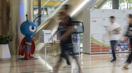 People walk past the Ant Group Co. mascot displayed at the company's headquarters in Hangzhou, China. (Bloomberg)
