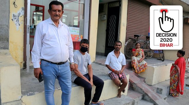 Ganga Thakur with other migrants of Bihar at his shop in Ludhiana's Sarpanch Colony. (Express Photo by Gurmeet Singh)