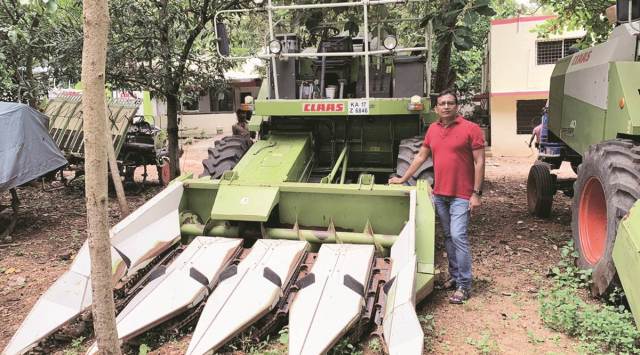 Harvesting entrepreneur Ramesh Babu with a maize header combine at his workshop in Davanagere, Karnataka.