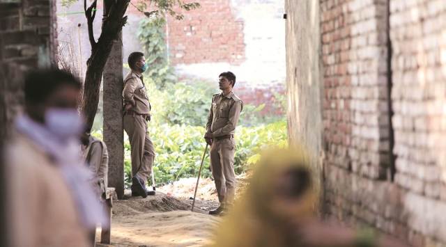 Hathras gangrape: Policemen at the victim’s village, a day after her cremation. (Express photo by Gajendra Yadav)