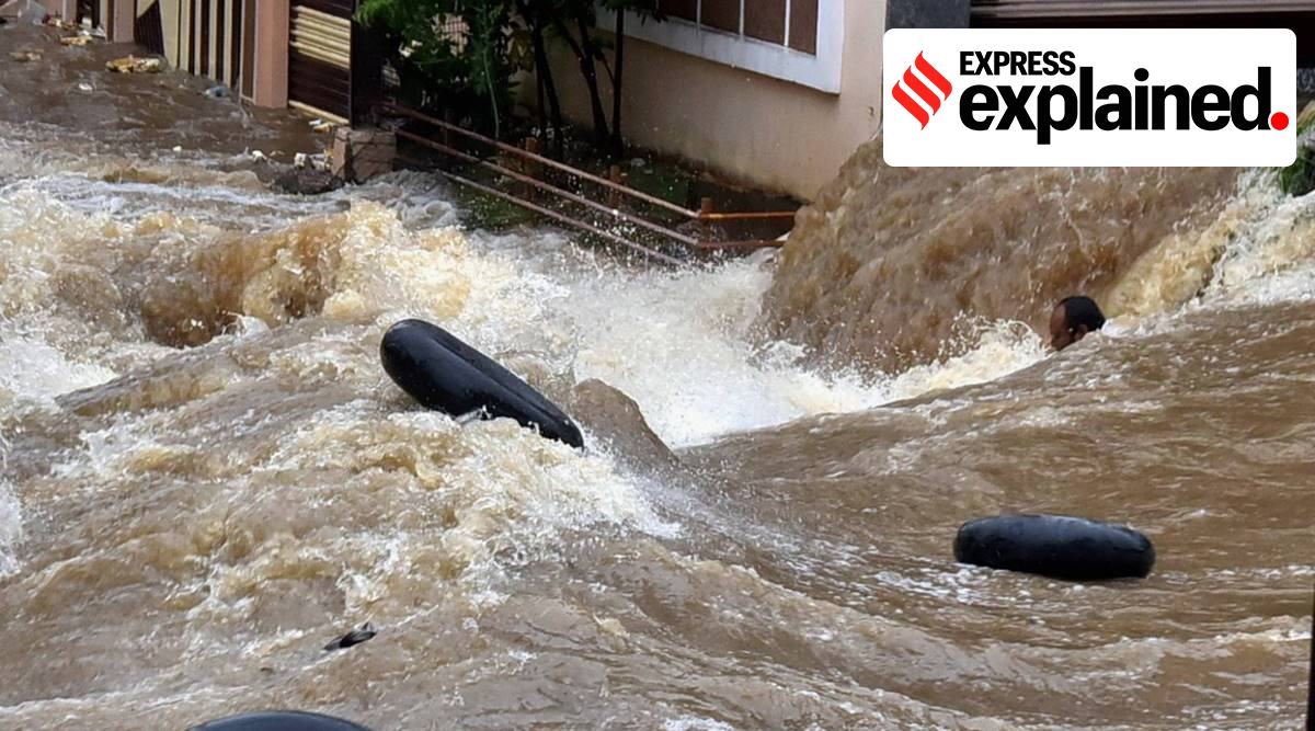 A man struggles to stay afloat in gushing floodwater following heavy rains in Hyderabad, on October 14. (Photo: PTI)
