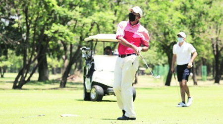 Jeev Milkha Singh and Ajeetesh Sandhu play with masks on after Chandigarh Golf Club reopened. Express