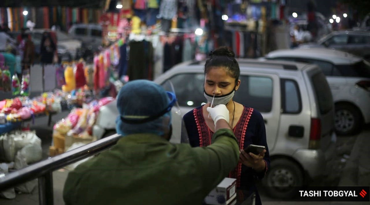 People get tested for Covid 19 at a weekly market in Patparganj, New Delhi on Wednesday. (Express Photograph by Tashi Tobgyal)