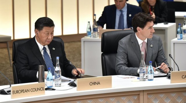 Xi Jinping, China's president, left, and Justin Trudeau, Canada's prime minister, attend a session at the Group of 20 (G-20) summit in Osaka, Japan. (Bloomberg)