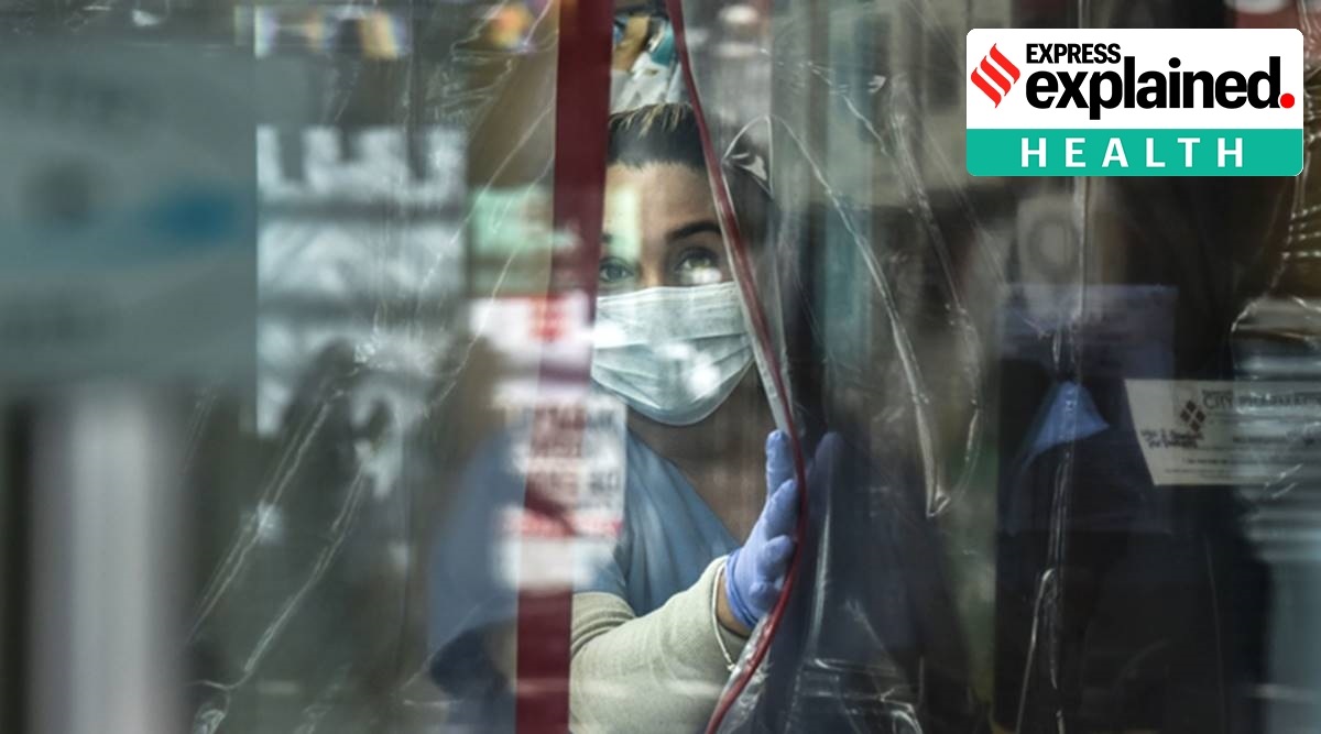 A pharmacist works while wearing personal protective equipment in the Elmhurst neighborhood in New York City (Photo by Stephanie Keith/Getty Images)