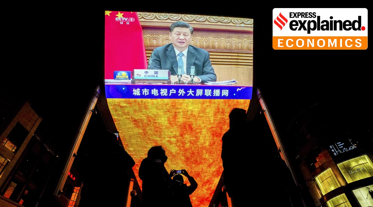 People with face masks gather near a giant TV screen broadcasting news of Chinese President Xi Jinping, at a shopping mall in Beijing, Sunday, Nov. 22, 2020. (AP Photo: Andy Wong, File)