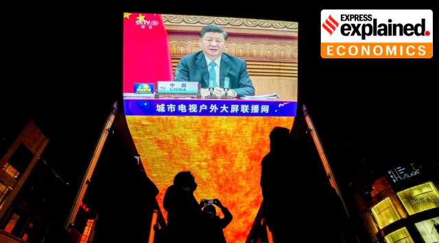 People with face masks gather near a giant TV screen broadcasting news of Chinese President Xi Jinping, at a shopping mall in Beijing, Sunday, Nov. 22, 2020. (AP Photo: Andy Wong, File)