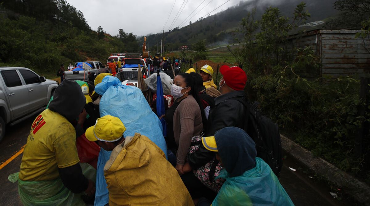 Residents traveling in the bed of a pickup truck wait on a road blocked by debris brought on by a landslide in the aftermath of Hurricane Eta, in Purulha, northern Guatemala Friday, Nov. 6, 2020. (AP Photo/Moises Castillo)


