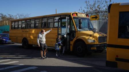Students get on a school bus outside PS 110 after school in Queens, Wednesday, Nov. 18, 2020.  (Anna Watts/The New York Times)