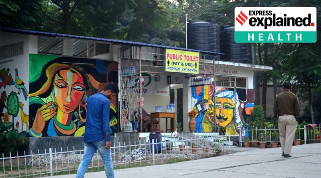 People pass a public toilet in Guwahati on Monday. (Express Photo: Dasarath Deka)