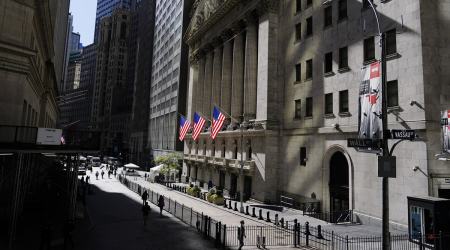 Pedestrians pass the New York Stock Exchange, in New York. 