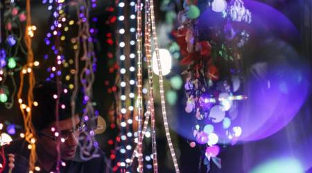A customer looks at strings of light-emitting diodes (LED) at an electronics store during the festival of Dhanteras in the Dadar market area of Mumbai, India, on Monday, Nov. 9, 2015. (Photographer: Dhiraj Singh/Bloomberg)