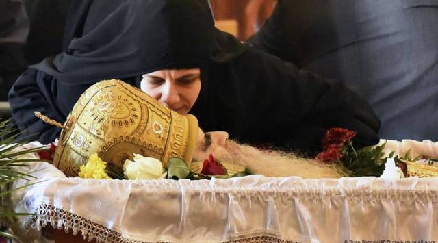 Mourners 'kiss' coronavirus infected bishop at Montenegro funeral