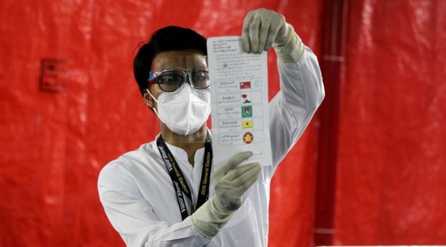 An official of the Union Election Commission counts ballots at a polling station Sunday, Nov. 8, 2020, in Yangon, Myanmar. (AP Photo: Thein Zaw)