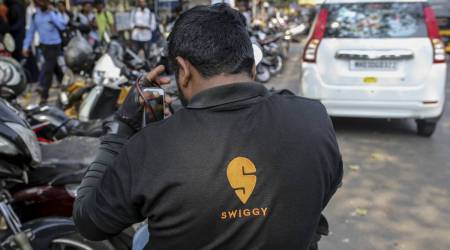 A food delivery rider for Swiggy, operated by Bundl Technologies Pvt., sits on a motorcycle in Mumbai, India, on Monday, Feb. 3, 2020. (Photographer: Dhiraj Singh/Bloomberg)