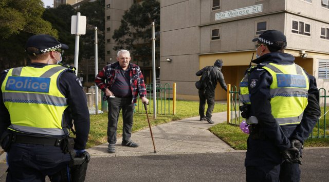 Police stand outside public housing towers that are a hotspot for COVID-19 in Melbourne Friday, July 10, 2020. Australia's Victoria state reported the new daily record of coronavirus cases. (Daniel Pockett/AAP Image via AP)