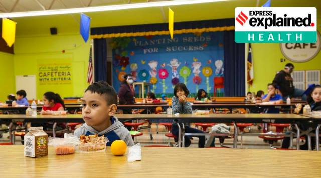 Second grader student eats his lunch socially distanced from his fellow students in the cafeteria at Perez Elementary School during the coronavirus pandemic, Thursday, Dec. 3, 2020, in Brownsville, Texas. (Denise Cathey/The Brownsville Herald via AP)