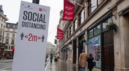 People pass closed shops on Regent Street, in London on Monday Dec. 21, 2020. (Dominic Lipinski/PA Wire(/PA via AP)