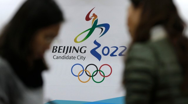 FILE - In this Nov. 4, 2014, file photo, journalists chat near the Beijing's bid for the 2022 Winter Olympics logo after attending a media briefing at the Beijing Olympics Headquarters in Beijing, China. (AP)