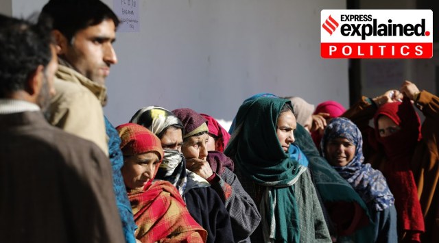 J&K DDC polls: People stand in queue to cast their votes in Arath area of Budgam district on December 16, 2020. (Express Photo: Shuaib Masoodi) 