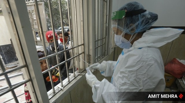 A health worker collects swab samples for Covid-19 testing at East Delhi, Wednesday. 