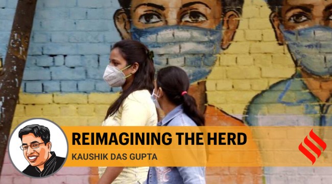 Women walk past a graffiti amid the spread of the coronavirus disease (Covid-19) in New Delhi (Express Photo By Amit Mehra)