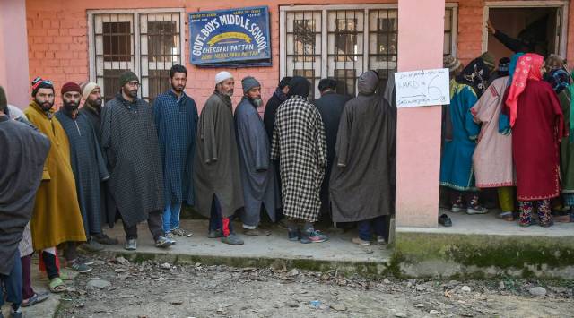 Residents stand in a queue to cast their votes outside a polling station during the eight and last phase of the District Development Council (DDC) elections, at Pattan in Baramulla (PTI)