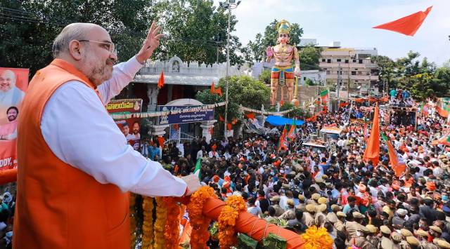 Home Minister Amit Shah waves to his supporters during his roadshow, in Secunderabad. (PTI Photo)