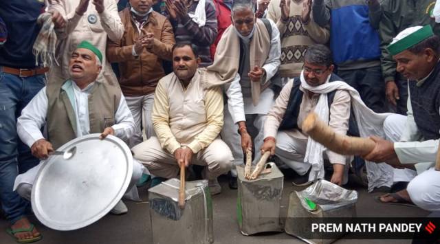 Farmers beating utensils as a protest against PM Modi's Man ki Baat program at the Ghazipur Border in New Delhi on Sunday. (Express Photo/Prem Nath Pandey)