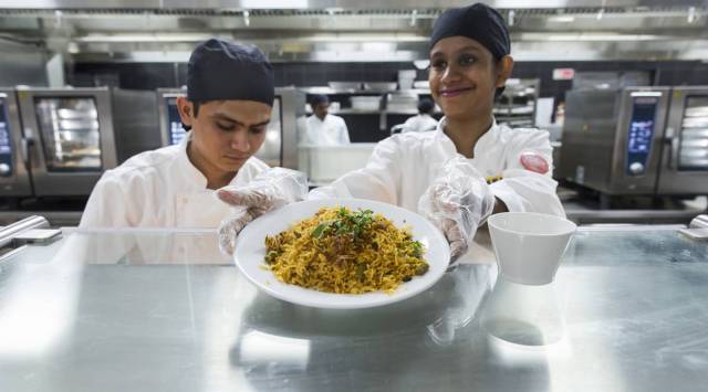 An employee serves a plate of biryani rice at the restaurant inside the Ikea store in Hitech City on the outskirts of Hyderabad, India, on Thursday, Aug. 9, 2018. (Photographer: Udit Kulshrestha/Bloomberg)