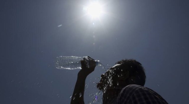 A man pours water on his face during a hot summer day in Hyderabad. (AP Photo/File)