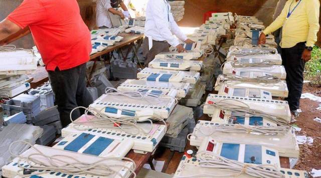 Officials check EVMs at a distribution centre ahead of local body elections, in Kozhikode last months. (Photo: PTI)