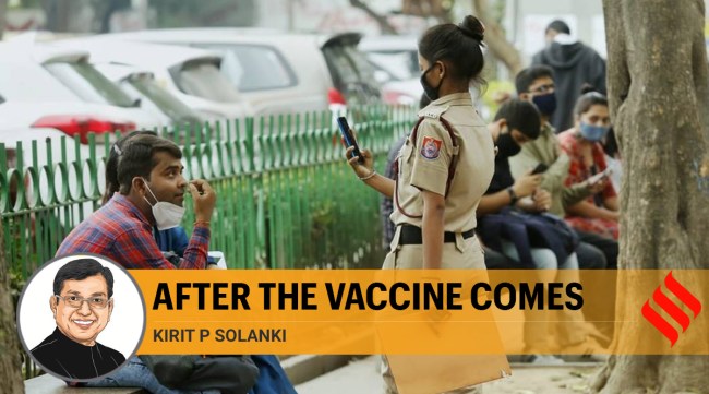 Delhi police officer takes photo of people who are not wearing mask in the capital (Express photo/Praveen Khanna)