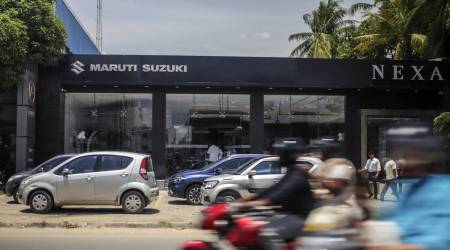 Motorcyclists ride past a Maruti Suzuki India Ltd. showroom in the Ambattur district of Chennai, India, on Friday, Aug. 30, 2019. (Photographer: Dhiraj Singh/Bloomberg)
