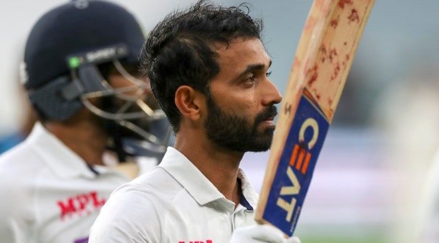 Ajinkya Rahane waves his bat to the crowd as he leaves the field following play on day two of the second cricket Test between India and Australia at the Melbourne Cricket Ground (Source: AP)