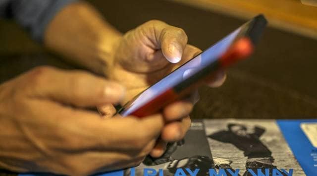 A man uses a smartphone in an arranged photograph taken in Mumbai, India, on Saturday, Feb. 15, 2020. (Photographer: Dhiraj Singh/Bloomberg)