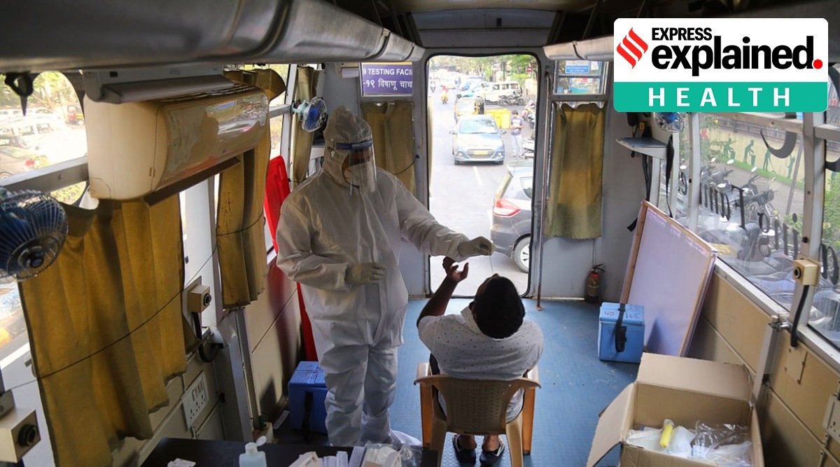 Swab collection for Covid-19 test in progress inside a NMMC mobile testing facility at Vashi (Express photo by Amit Chakravarty)